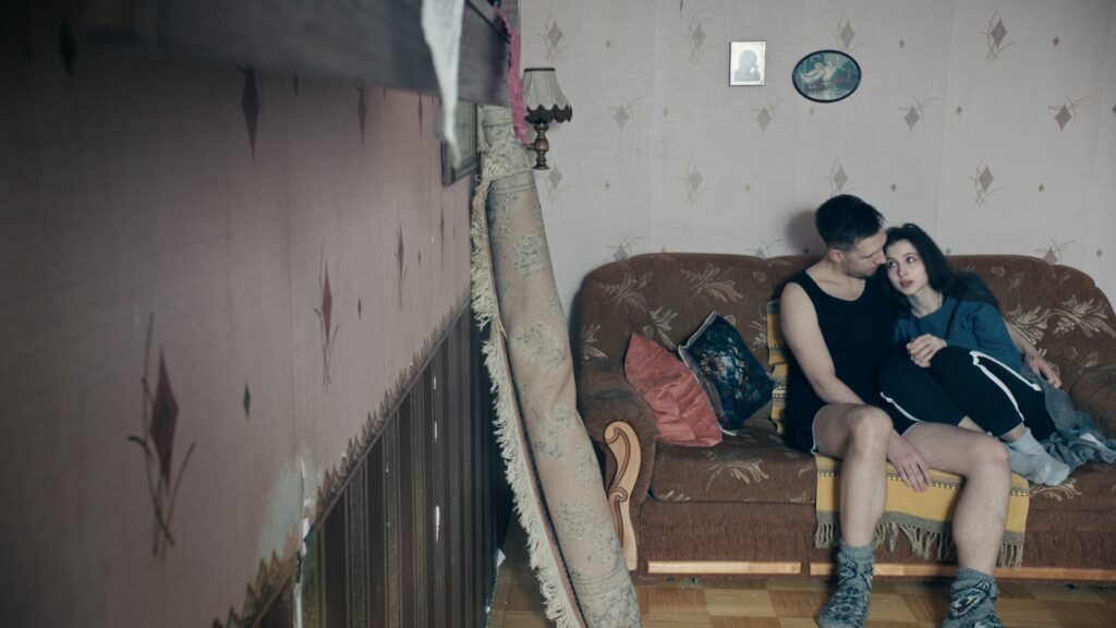 Screencap from the movie You Shouldn't Play Alone, displaying the cold and desolated environment of winter Estonia in the Russian comunity, and the life of Anna and Jevgeny and their troubled relationship