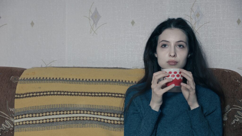 Screencap from the movie You Shouldn't Play Alone, displaying the cold and desolated environment of winter Estonia in the Russian comunity, and the life of Anna and Jevgeny and their troubled relationship