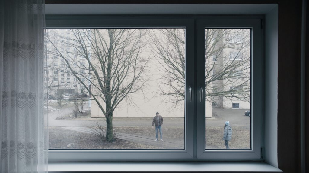 Screencap from the movie You Shouldn't Play Alone, displaying the cold and desolated environment of winter Estonia in the Russian comunity, and the life of Anna and Jevgeny and their troubled relationship
